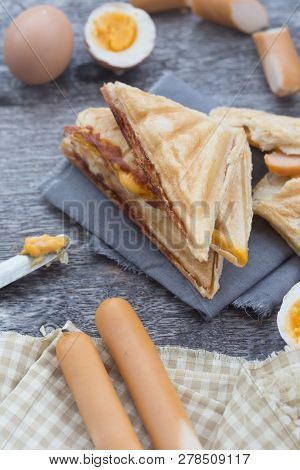 Pressed And Toasted Double Panini With Ham And Cheese Served On Sandwich Paper On A Wooden Table,egg