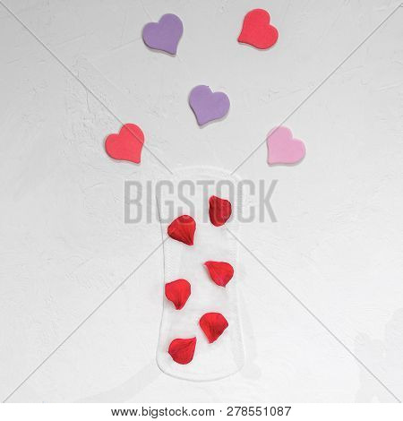 Red Petals On A Female Daily Lining And Decorative Hearts. Close-up. The Minimum. Flat Lay