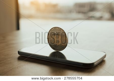Bitcoin Symbol On Smartphone Screen And Cryptography Concept.