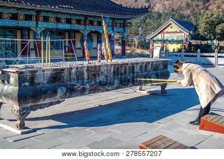Woman Near The Censer With Is Holding A Burning Joss Aroma Incense Sticks Or Candles And Worships In