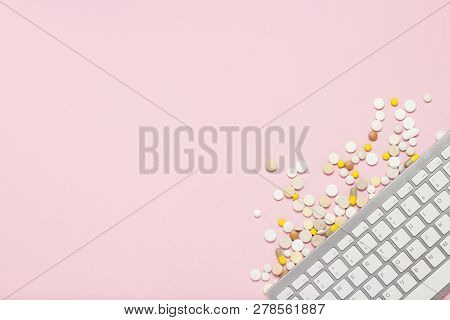 Keyboard And Pills On Pink Background. The Concept Of Ordering And Buying Medicines, Vitamins And Pi