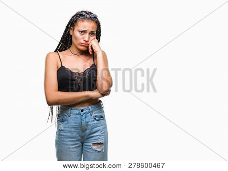 Young braided hair african american with pigmentation blemish birth mark over isolated background looking stressed and nervous with hands on mouth biting nails. Anxiety problem.