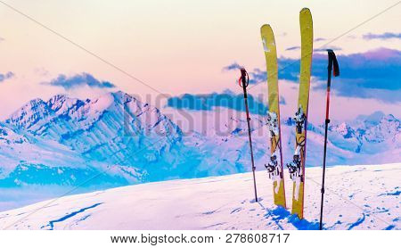 Ski in winter season, mountains and ski touring backcountry equipments on the top of snowy mountains in sunny day, Verbier Switzerland.