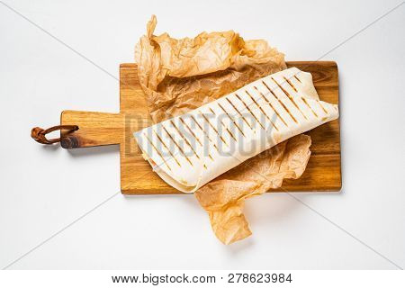 Chicken fajita wrap sandwich close up on wooden board