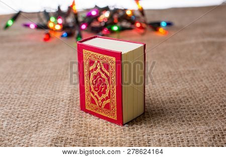 Islamic Holy Book Quran With Lights Behind