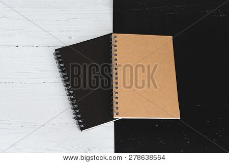 Black And Sand Sprial Notebooks On Black And White Surface, Contrasty Minimalist Flatlay