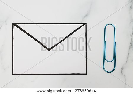 Funny Metaphor Of Inbox With Email Envelop And Attachment Clip On Real-life Desk