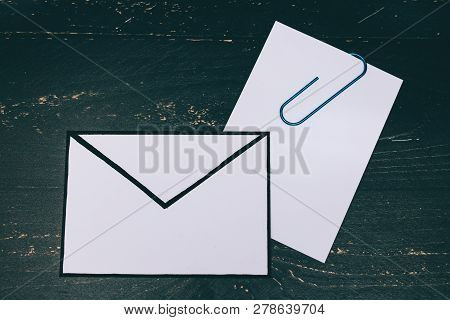 Funny Metaphor Of Inbox With Email Envelop And Attachment Clip On Real-life Desk