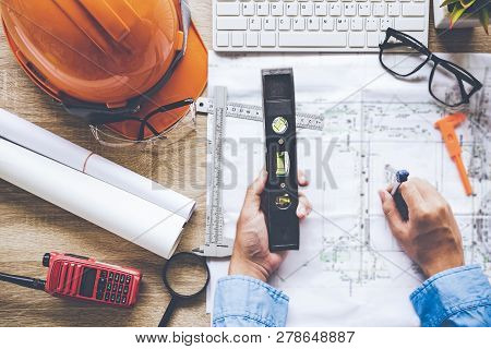 Top View Architect Working On Blueprint. Architects Workplace.  Engineer Tools And Safety Control,  