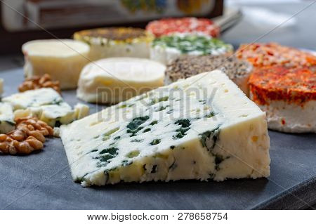 Assortment Of French Fresh White Soft Goat Cheeses With Different Tastes Topping Made With Herbs, Pa