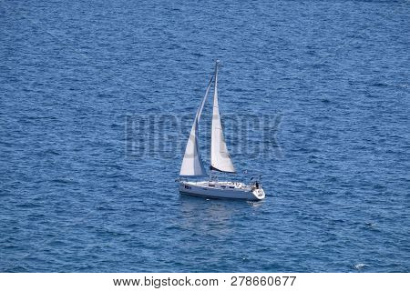 PORTOROZ, SLOVENIA - JUNE 26: White sailboat on open blue sea in Portoroz, Slovenia, on June 26, 2015.