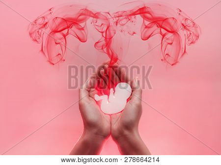Womans Palms Pressed Together And Keep Embryo From Paper. Red Lood Comes From The Baby In The Form O