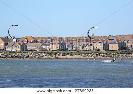 Kitesurfers Riding Their Boards In Portland Harbour