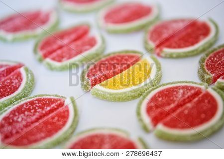 Marmalade In The Form Of Slices Of Watermelon And Lime Lies On A White Surface. Stand Out From The C