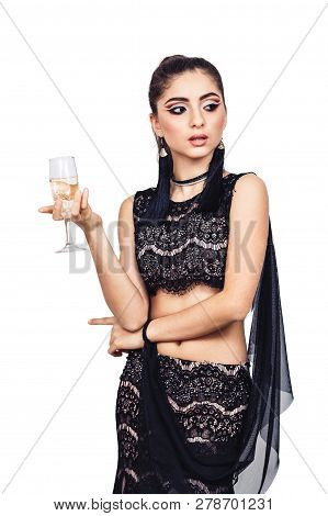 Elegant Young Girl Posing With A Glass Of Champagne. Isolated On White