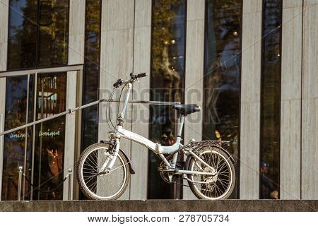 October 27, 2018. Germany, Dusseldorf. City Folding Bicycle Parked Background Building Complex Known