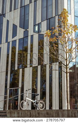 October 27, 2018. Germany, Dusseldorf. City Folding Bicycle Parked Background Building Complex Known