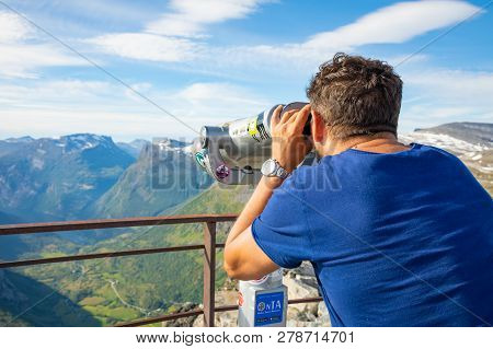 Dalsnibba, Norway - 26.06.2018: Man Looking In Binoculars On View Point Dalsnibba, View Of Gejranger