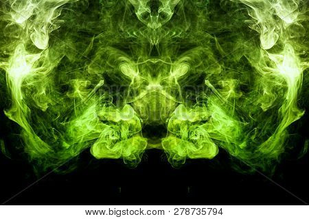 Dense Multicolored Smoke Of    Green Colors In The Form Of A Skull, Monster, Dragon On A Black Isola