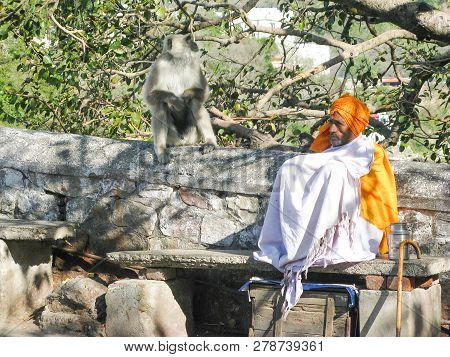 Rishikesh, State Uttarakhand, India - March 03, 2014: Indian Pilgrim Sadhu In A White Cape And Orang