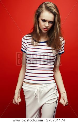 Young Pretty Teenage Girl On Bright Red Background, Happy Smilin