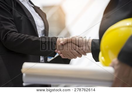 Business People Handshake (shaking Hands)with Partnership At Construction Site,engineer Holdind Draw