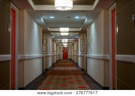 POV of walking in long corridor at a hotel
