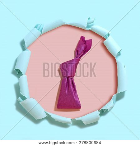 Homemade Easter Bunny Made Of Bright Pink Napkin. Pink Background Under Tattered Light Blue Paper Wi