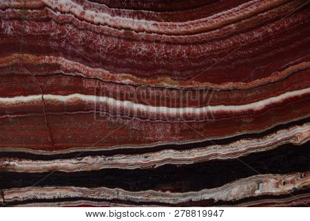 The Structure Of Onyx, A Bright Red Color With Thin Veins And Waves, Is Called Onice Fantastico