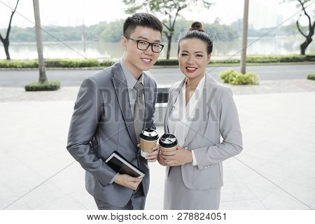 Portrait Of Happy Vietnamse Business Couple Smiling And Looking At Camera