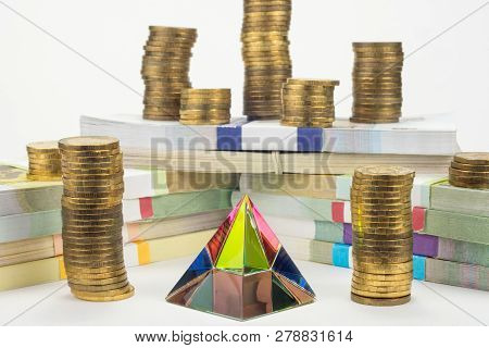 Glass Pyramid In The Center, Wads Of Money And Stacks Of Coins In The Background