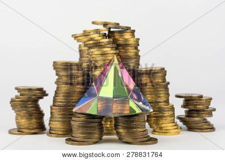 Glass Pyramid Stands On Stacks Of Coins