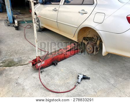 Photo Of An Old Are Parks In The Garage Waiting For Change A New Tyre In Local Garage Of Thailand Co