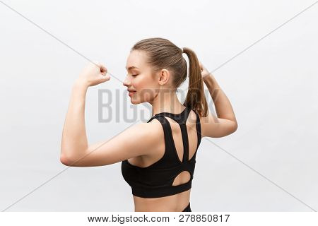 Waist Up Shot Of Sporty Woman Raises Hand To Show Her Muscles, Feels Confident In Victory, Looks Sto