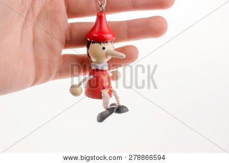 Pinocchio Puppet In Hand On A White Background