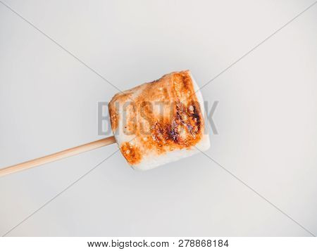 Roasted Marshmallows On A Skewer On White Background