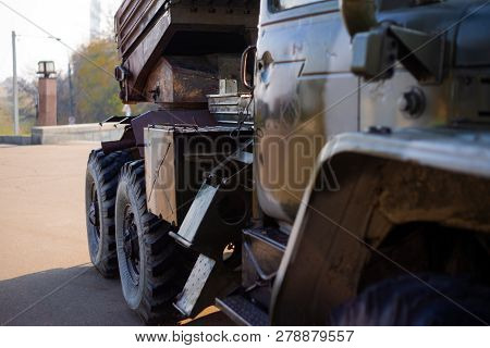 Camouflage Military Truck With Rocket Launcher. Outdoor Military Vehicles Museum. Armor Is Damaged A