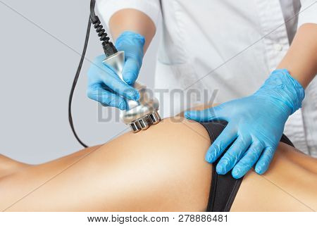 The Doctor Does The Rf Lifting Procedure On The Legs And Hips Of A Woman In A Beauty Parlor. Treatme