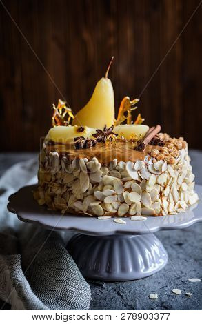 Layered Cake With Caramel Glaze, Decorated With Almond Slices, Pears, Spun Sugar Decorations And Cin