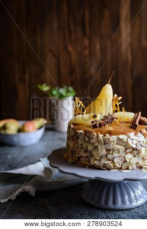 Layered Cake With Caramel Glaze, Decorated With Almond Slices, Pears, Spun Sugar Decorations And Cin