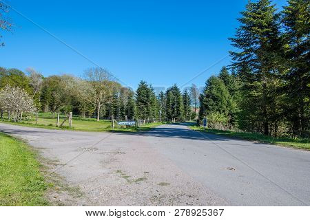 Small Danish Countryside Road With A Sign Showing The Way To Liselund Palace On Island Of Moen