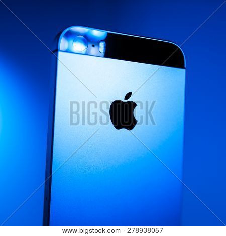 Paris, France - Apr 21, 2016: Newest Apple Computers Iphone Se Smartphone After Unboxing On Blue Bac
