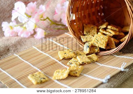 Chinese New Year Homemade Cookies With Sesame Seeds, On Bamboo Stick , On Sackcloth Background