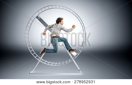 man running in huge hamster wheele