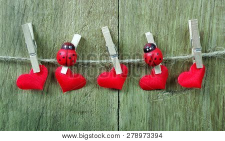 Love Hearts Hanging On Rope On A Wooden Background. Love Concept. Copy Spaces