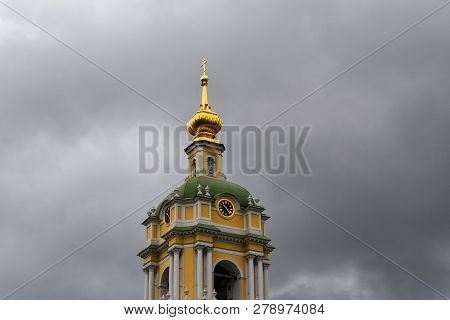 Bell Tower Of Novospassky Monastery In Moscow Against A Dark Cloudy Sky. Russia