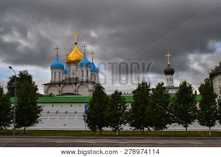 Russia, Moscow, July 2018 - Novospassky Monastery. Domes Of The Temple Against The Dark Cloudy Sky