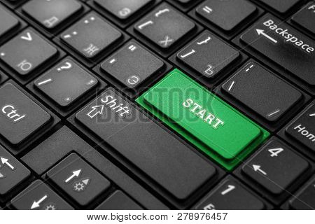 Closeup Of A Green Button With The Word Start, On A Black Keyboard. Creative Background, Copy Space.