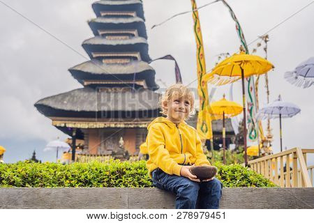 Boy Traveler In The Background Of Pura Ulun Danu Bratan, Bali. Hindu Temple Surrounded By Flowers On