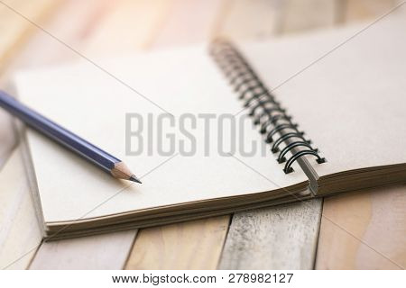Notepad With Pencil On Wood Board Background.using Wallpaper For Education, Business Photo.take Note
